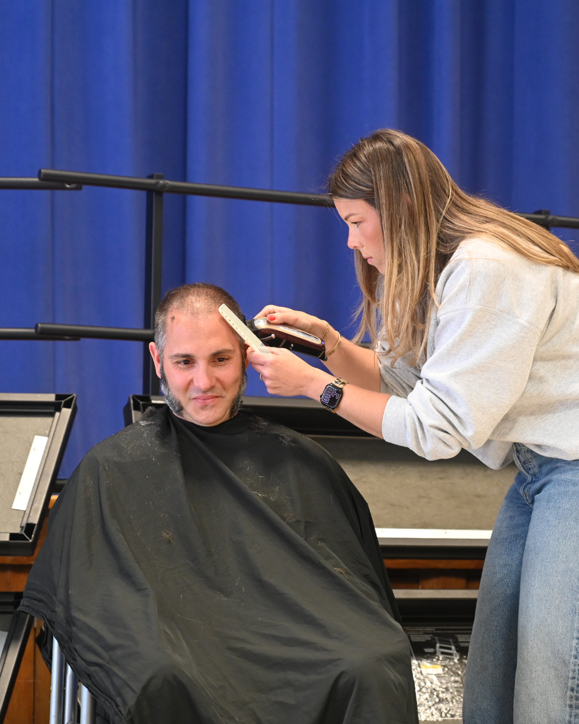 Alex Cook gives Mr. Turcio a haircut