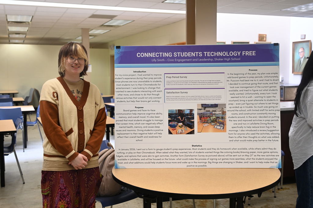 student posing with a sign stating connecting students technology free