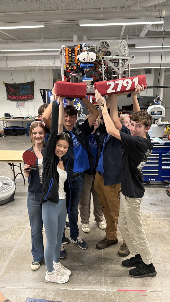 robotics students standing together after winning championships
