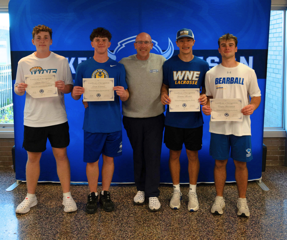 Boys lacrosse players with Coach Hennessey