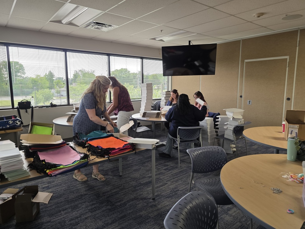 Sunmark employees work at tables to put items into Gleeboxxes.