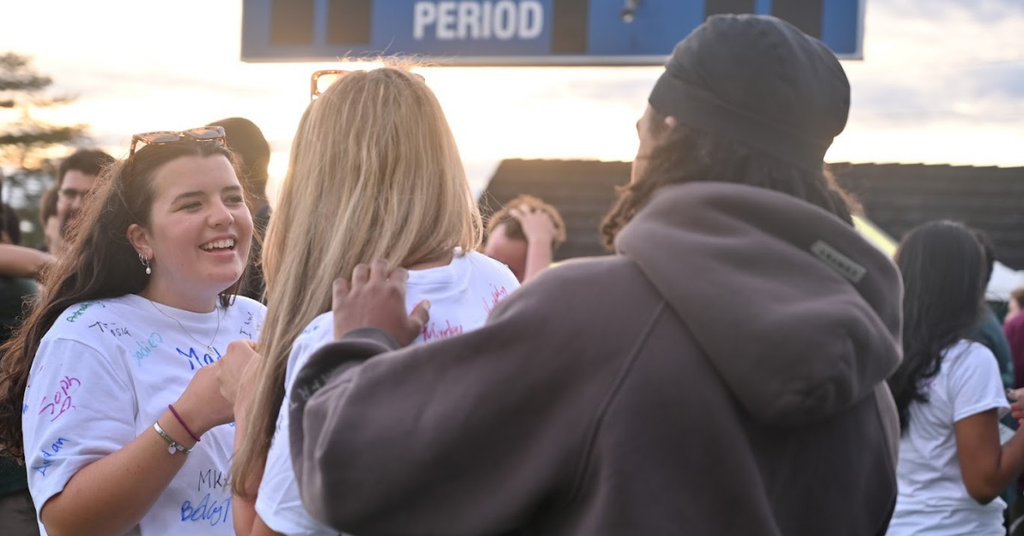 Student signing shirt