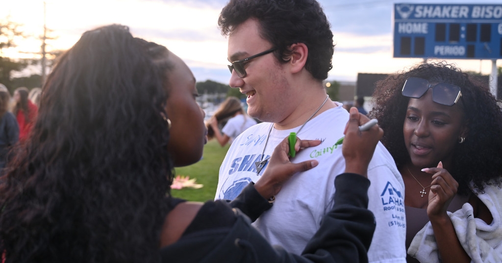 Students signing shirt