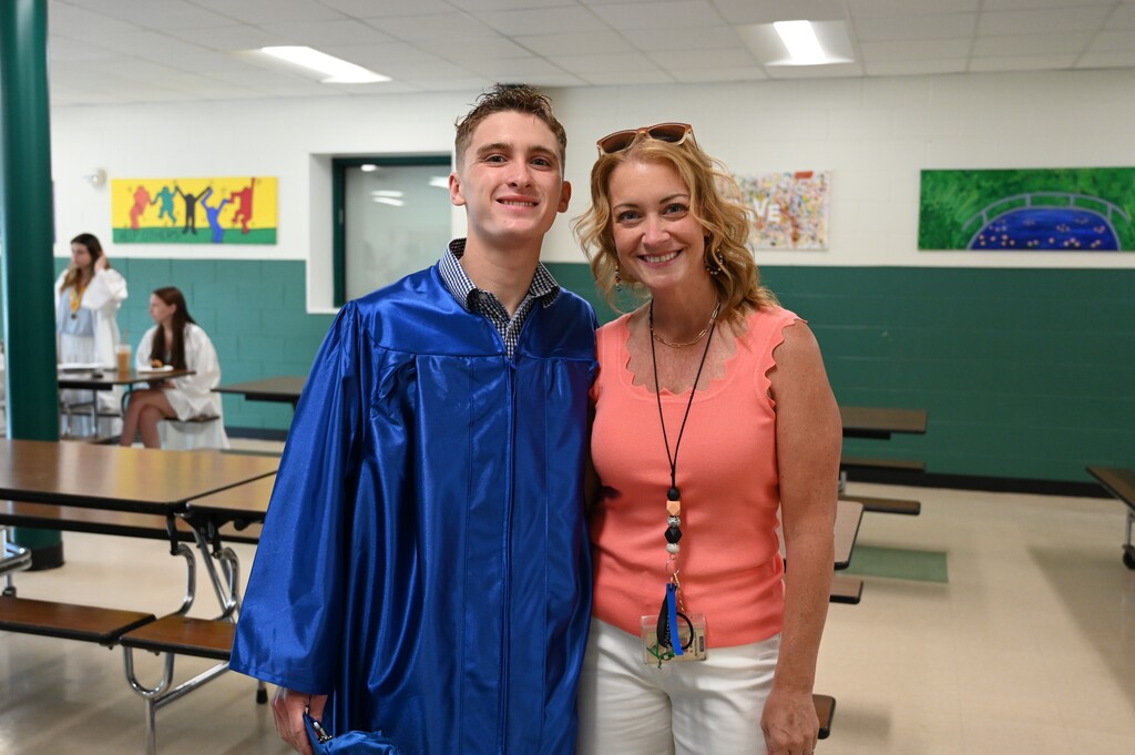 A teacher poses with her son, who is a graduating senior.