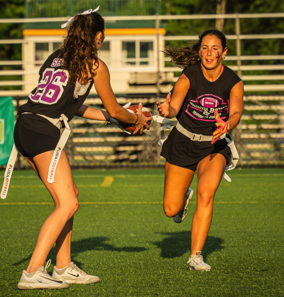 One player hands the ball off to another.