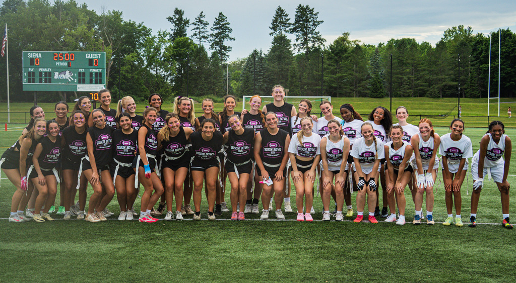 Juniors and seniors pose together on the field before the Bison Bowl.
