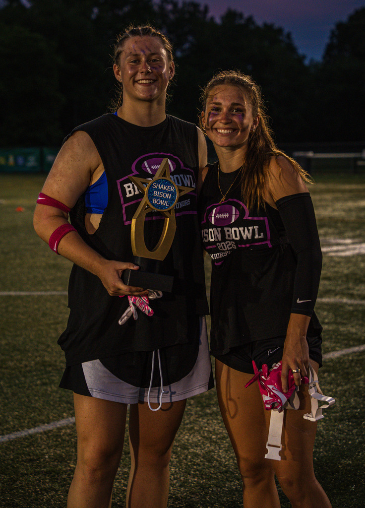 Two members of the senior team pose with the trophy.