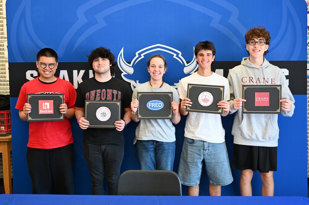 Five students pose with the certificate of college choice for music.