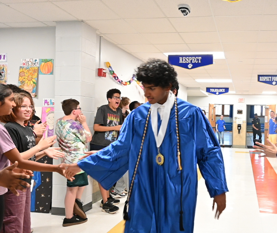 Shaker senior high-fives Menands students