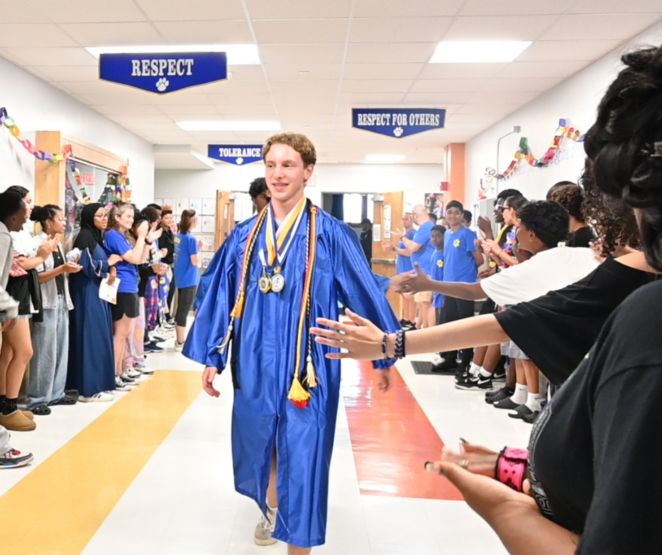 Shaker senior high-fives Menands students