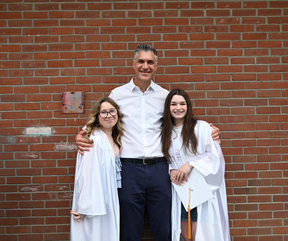 Two seniors pose for a picture with previous Boght Hills Principal, now Shaker High Principal, Mr. Marcus Puccioni