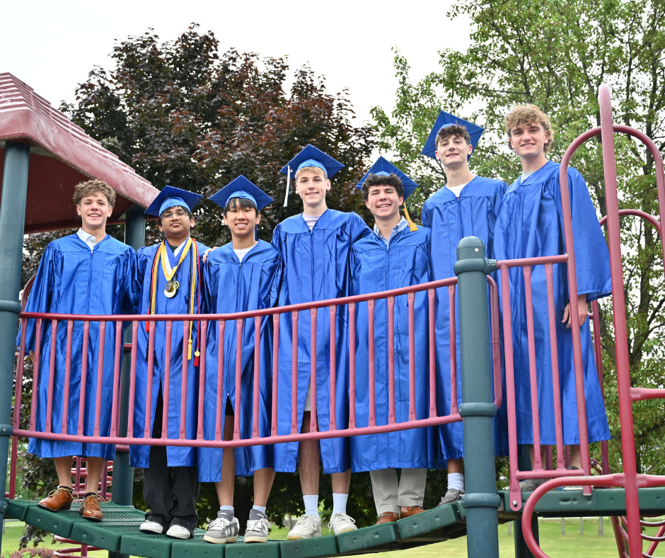 Seven seniors stand on the Boght Hills playground bridge