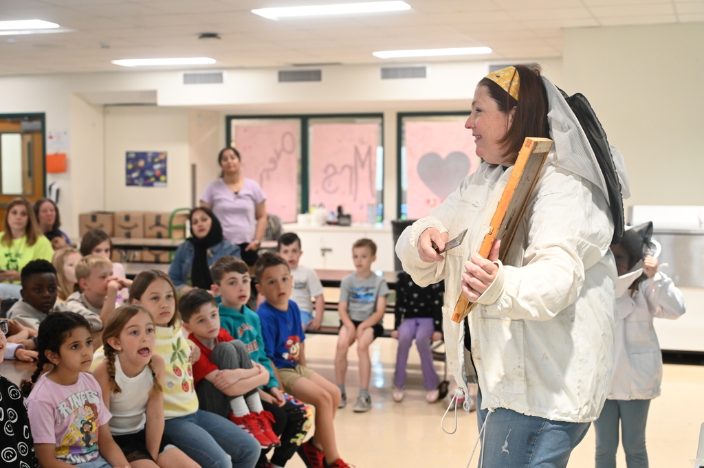 Mrs. Levitus shows off her tools for beekeeping to a group of students.