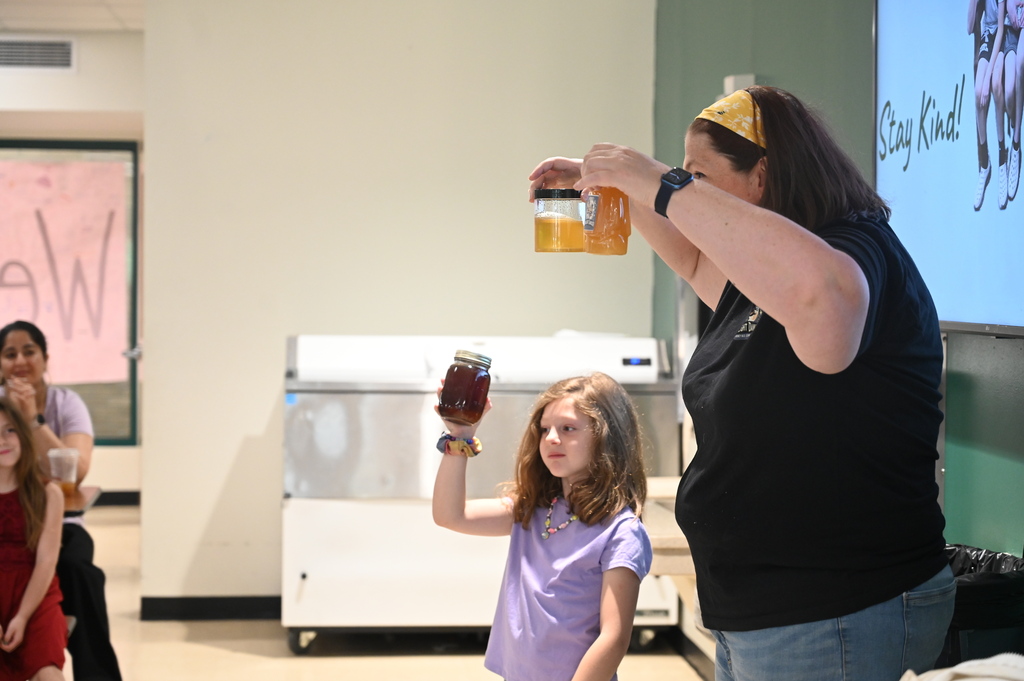 Mrs. Levitus and her daughter show off their honey production.