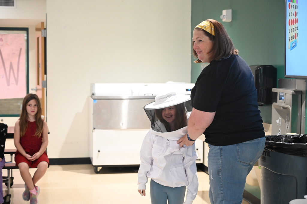 Mrs. Levitus dresses her daughter in protective gear.
