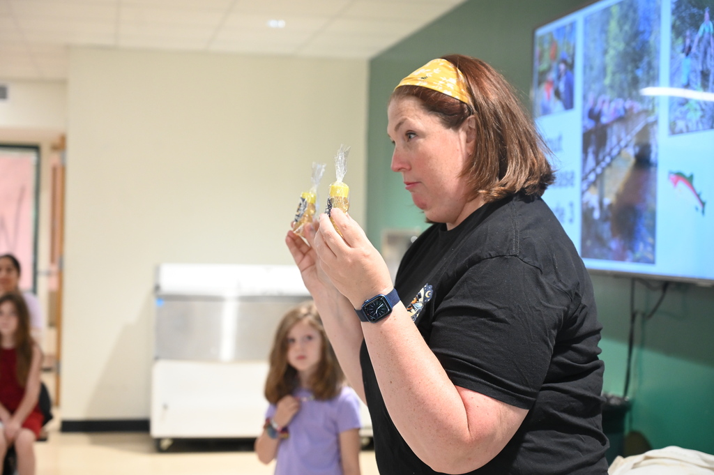 Mrs. Levitus shows off the small bottles of honey students will get to take home.