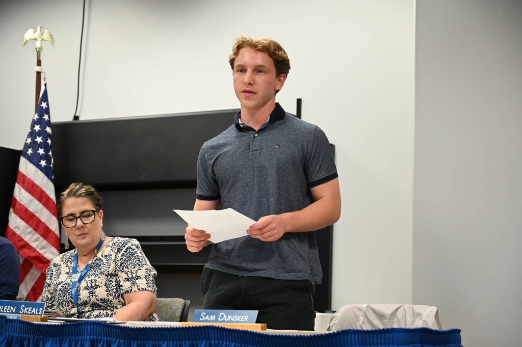 Student board member Sam Dunsker gives final report