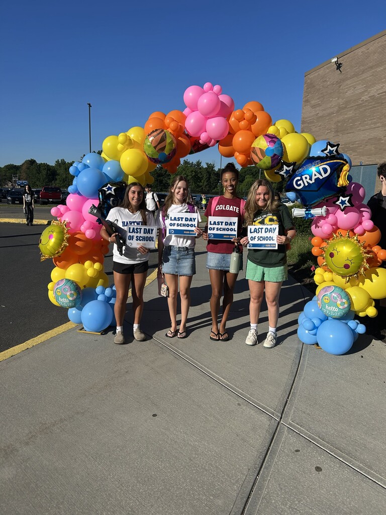 STUDENTS posing with last day of school signs