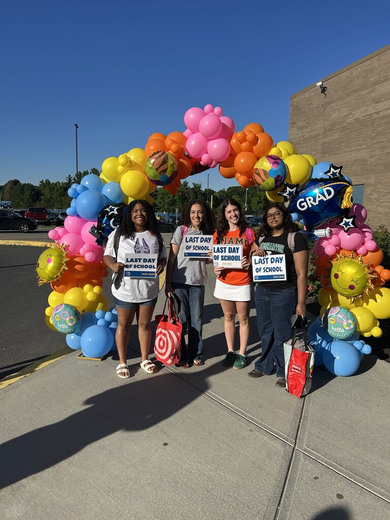 STUDENTS posing with last day of school signs