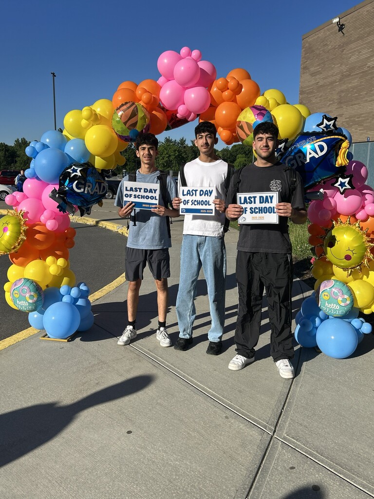 STUDENTS posing with last day of school signs