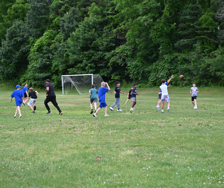Forts Ferry fifth graders play football with Dr. Casey Parker