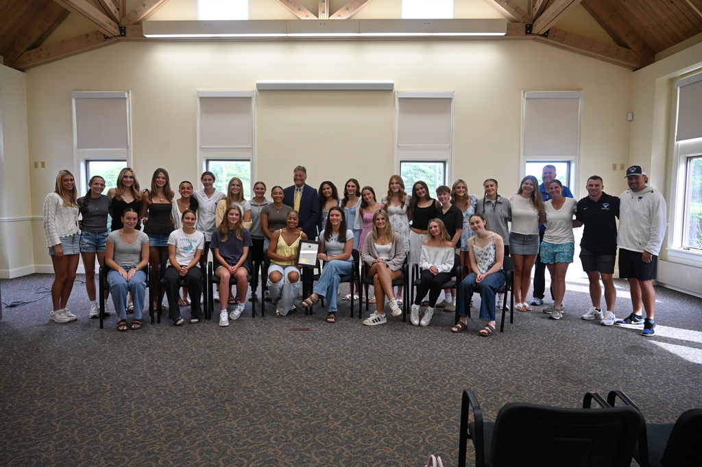 The Shaker girls flag football team poses with Colonie Town Supervisor Peter Crummey and a proclamation.