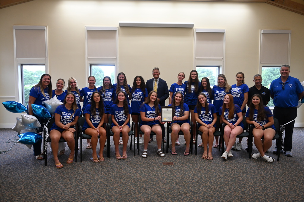 The Shaker girls lacrosse team poses with Town Supervisor Crummey.