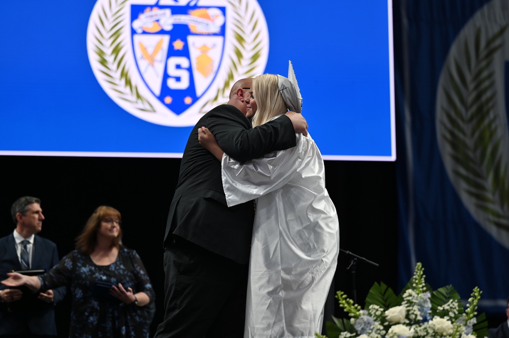 Graduate hugs dad