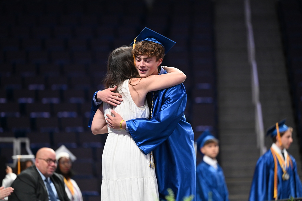 Graduate hugs mom