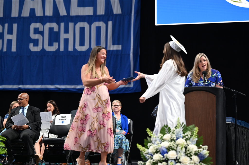 Graduate walks across stage to hug mom and recieve diploma