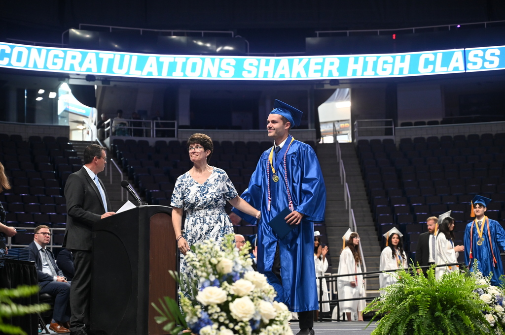 Graduate completes walking across stage with mom