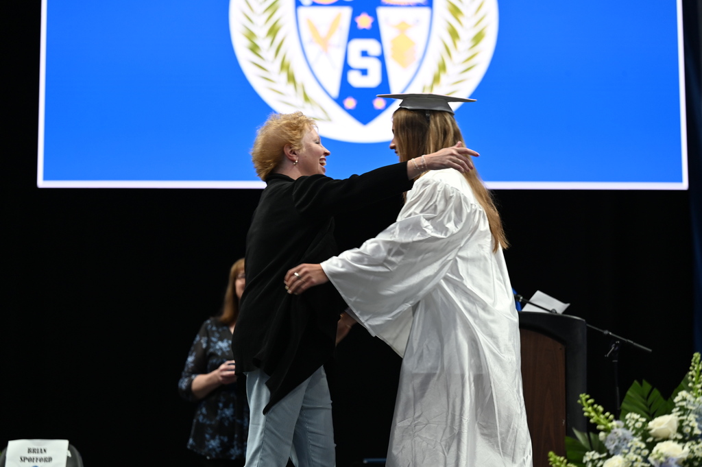 Graduate hugs mom