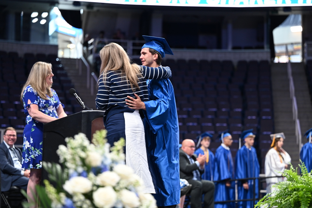 Graduate completes walking across stage with mom