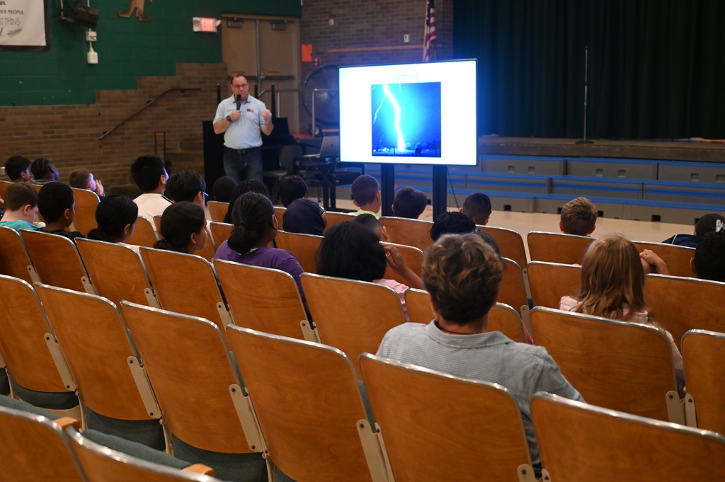 Paul standing in front with a screen showing a lightening strike