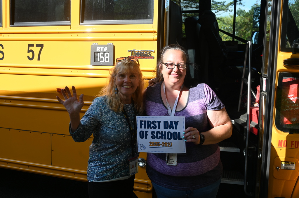 Bus driver and aide smile for first day of school