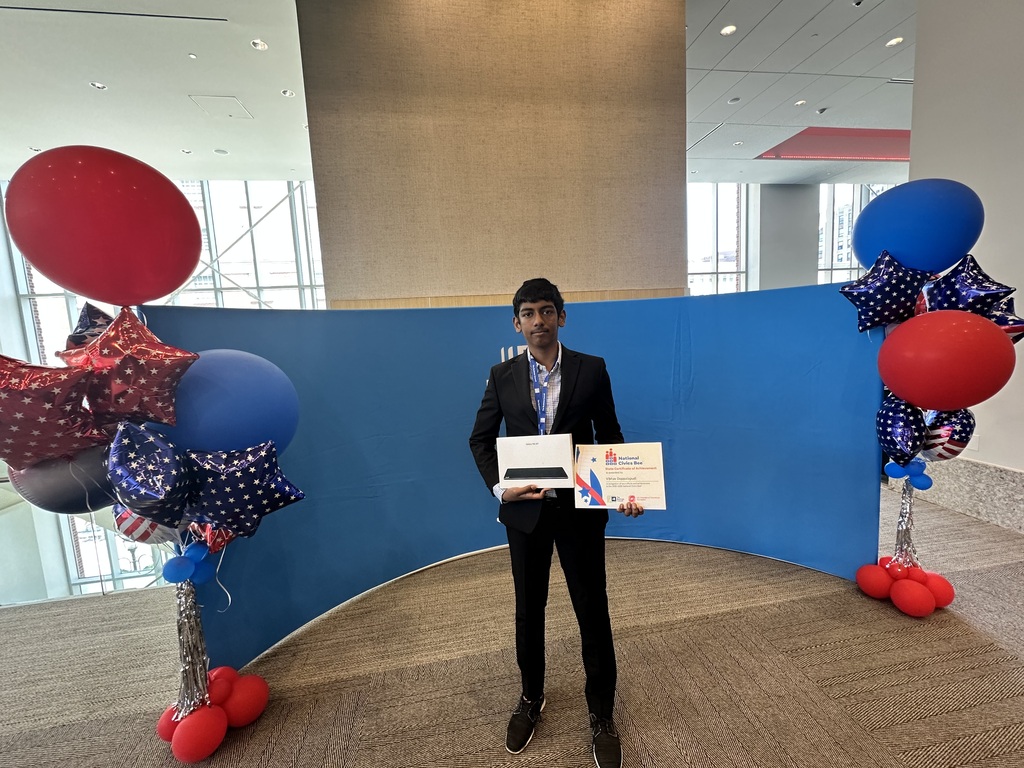 Vibhav Doppalapudi standing with two certificates, after placing in top 5 at civics bee for new york state