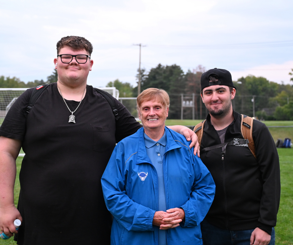 Miss Kay with seniors in front of the sunrise