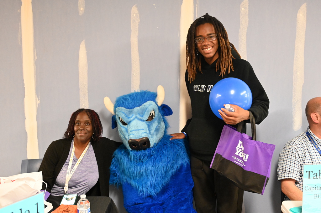 attendees posing with the bison