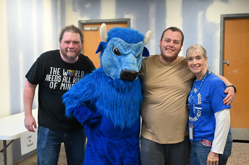 three teachers standing with the bison posing