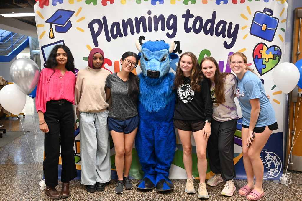 group of six female students posing with the bison
