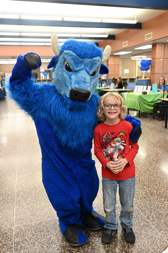 student posing with the bison
