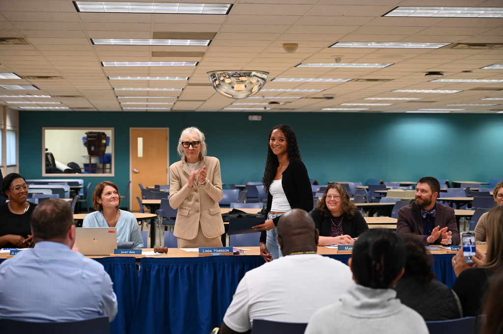 The Board of Education members clap for Mia Thomas as she receives recognition as the September Kids Care recipient.