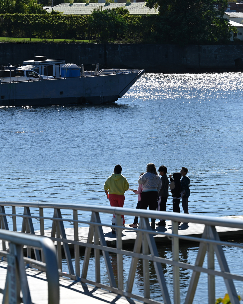 Students watch boat pass on Hudson River