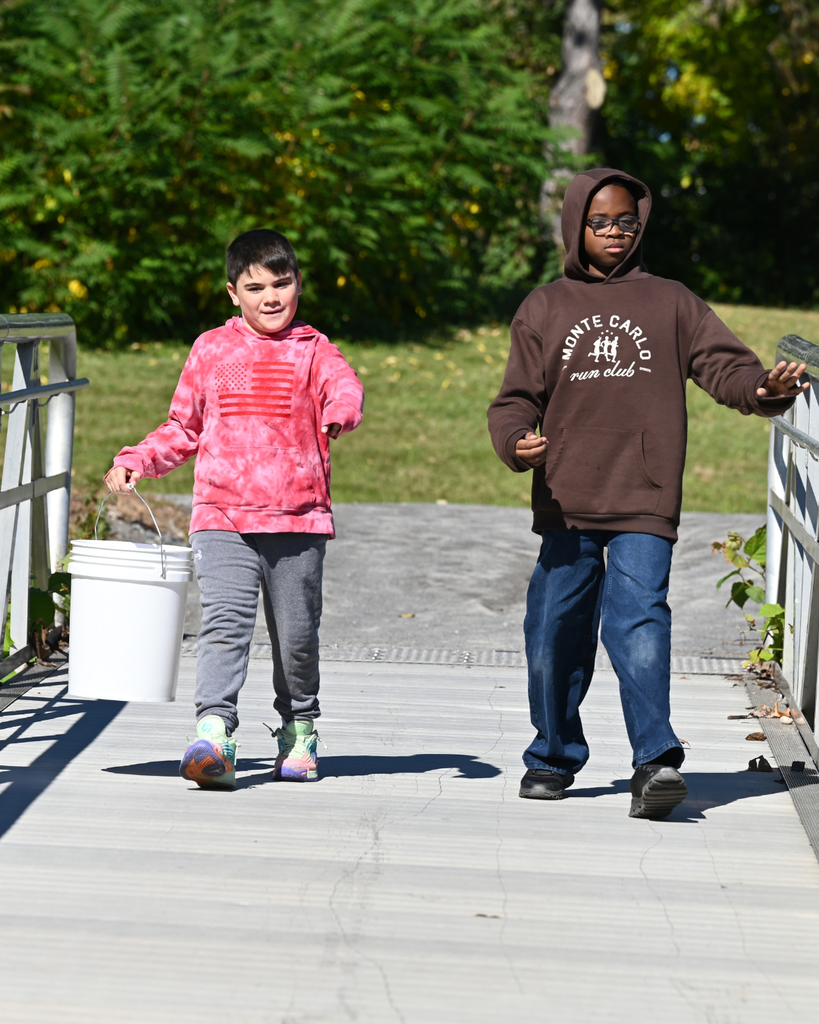 Students walk with bucket