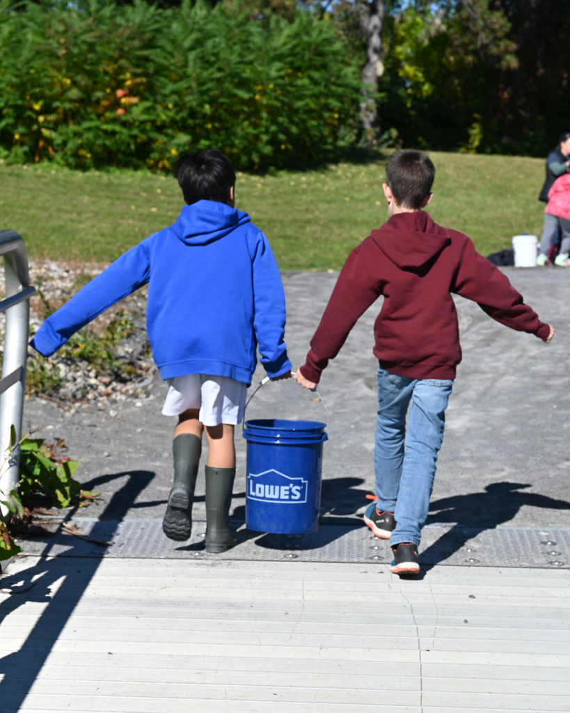 Students carry Hudson River water