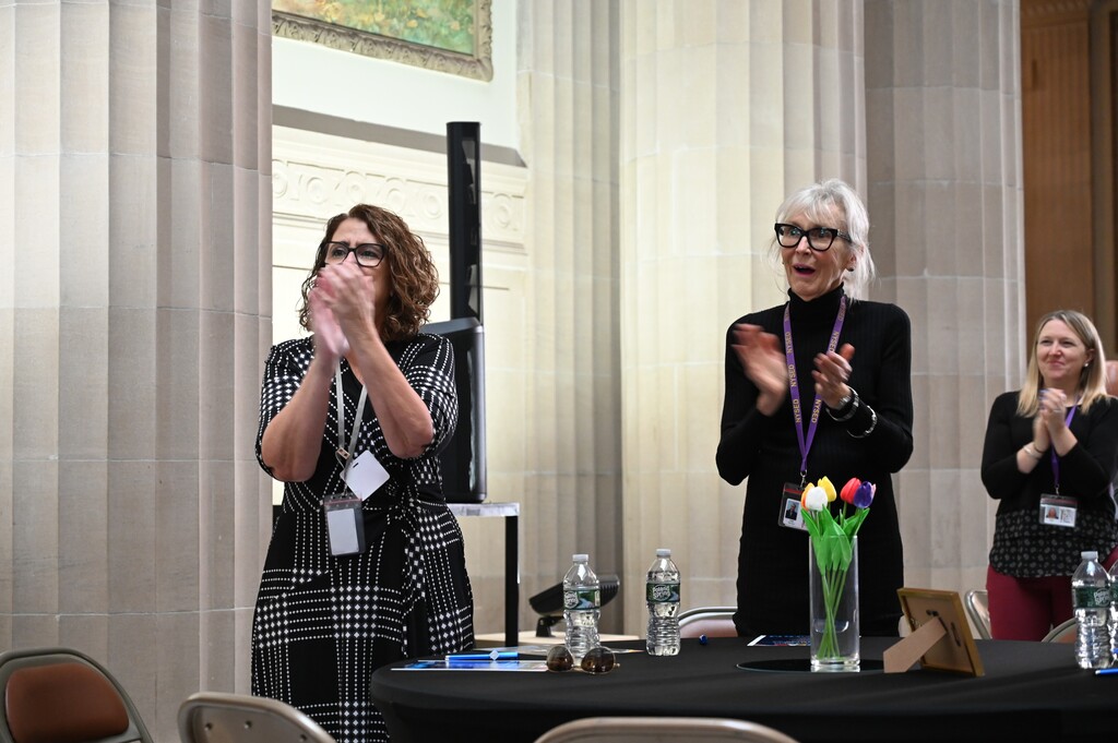 Superintendent Kathleen Skeals and Board of Education President Linda Harrison stand and applaud David's speech. 