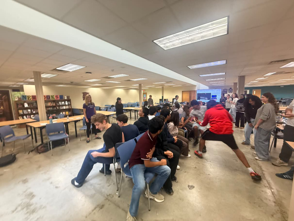 German club dancing together playing musical chairs, live action