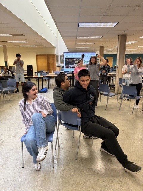 German club dancing together playing musical chairs, live action