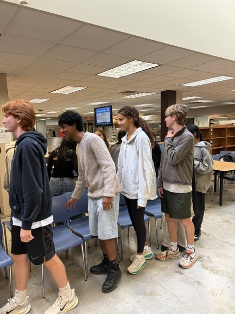 German club dancing together playing musical chairs, live action