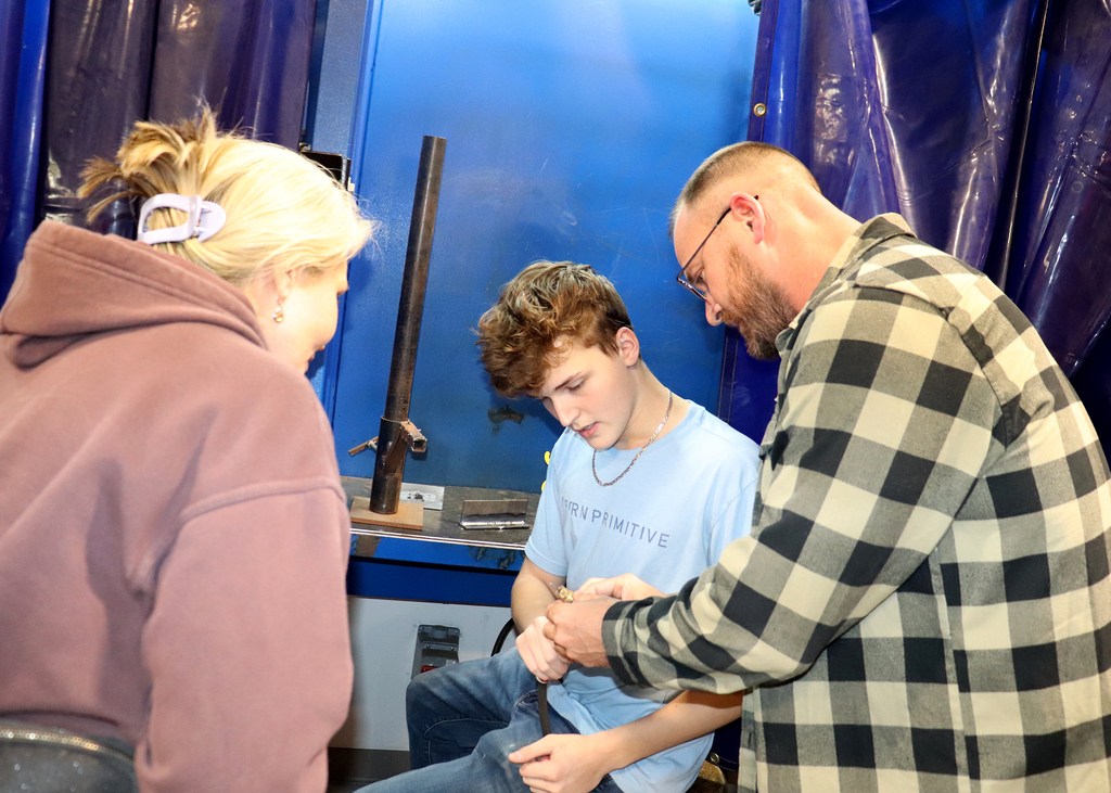 Capital Region BOCES senior Tyler Jourdanais shows welding equipment to his parents Theresa and Floyd Jourdanais during an open house Thursday at the Career and Technical Education  (CTE) Center - Albany Campus
